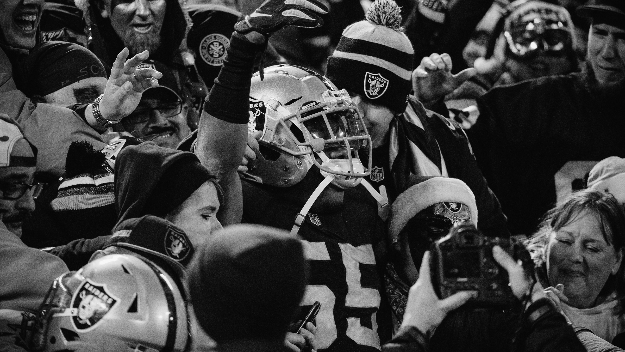 Raiders player in the crowd, black and white